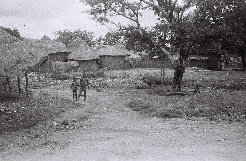 Women carrying pots up from a river landing near Bida.